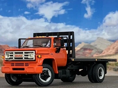 1/64 DCP ORANGE GMC 6500 SINGLE AXLE FLATBED - Image 1 of 4