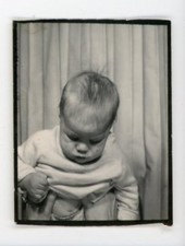 Hidden mother - Hands holding  baby in   photobooth.   Vintage photo booth
