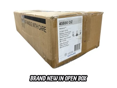 Luz de tocador de baño de bronce antiguo de 3 luces KICHLER Winslow con vidrio transparente de semillas Foto 1 de 4