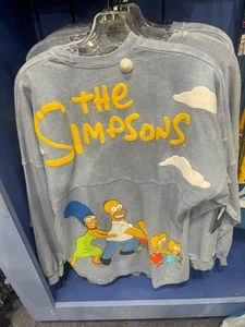 Universal Studios The Simpsons Light Blue Spirit Jersey Shirt NWT - Bild 1 von 2