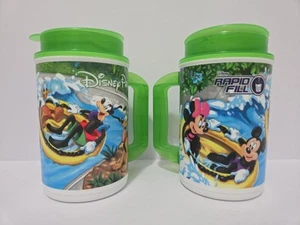 Set of 2 Disney Parks Rapid Souvenir Cup Fills Green Cover Whirley Drink Works - Picture 1 of 5