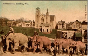 BARABOO, WISCONSIN - STREET SCENE - MEN RIDING ELEPHANTS - CIRCUS POSTCARD - Picture 1 of 2