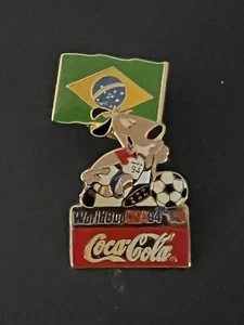 World Cup ‘94 Brazil Flag with Striker Mascot Coca-Cola Pin - Picture 1 of 2