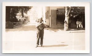Vintage Photo Man Holding Puppy US Sailors Grocery Store Street Scene - Picture 1 of 2