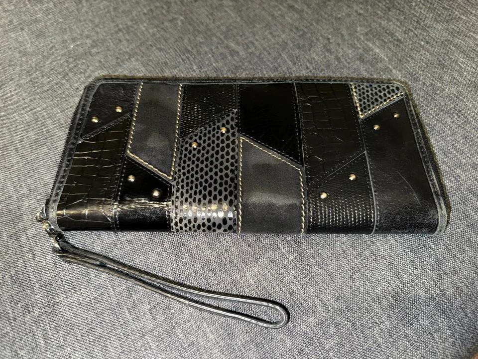 Muñequera con cremallera de viaje retazos de gamuza cuero negro soporte pasaporte fósil de colección C Foto 1 de 4