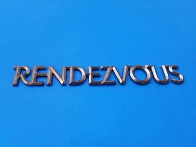 02 03 04 05 06 BUICK RENDEZVOUS EMBLEMA TRASERO PLATEADO LOGOTIPO INSIGNIA SÍMBOLO OEM (2003) Foto 1 de 3