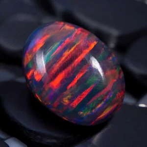 Cabujón ovalado de ópalo negro 14x10 mm 3,47 quilates AAA+ piedras preciosas sueltas - Imagen 1 de 6