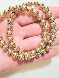 Bracciale elastico con sfere in oro giallo o rosa massiccio 8 mm 14 kt - Foto 1 di 9