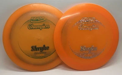 Lot of 2 Orange Innova Champion Shryke Disc Golf Distance Drivers, 169g And 175g - Image 1 of 4