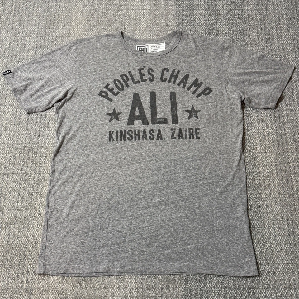 Camiseta Roots of Fight Muhammad Ali Peoples Champ Rumble Para Hombre XL Gris Foto 1 de 4