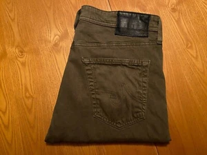 AG ADRIANO GOLDSCHMIED THE GRADUATE DUNKELGRÜNE ALGENSATIN JEANS 32 X 29,5 GEBRAUCHT, IN EINWANDFREIEM ZUSTAND - Bild 1 von 11