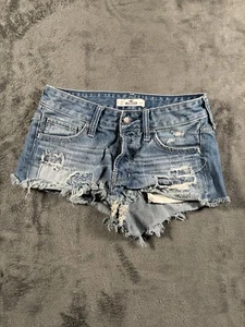 Hollister Denim Shorts Womens Sz 0 Blue Low Distressed Shorty Booty Cut Patchy - Picture 1 of 11
