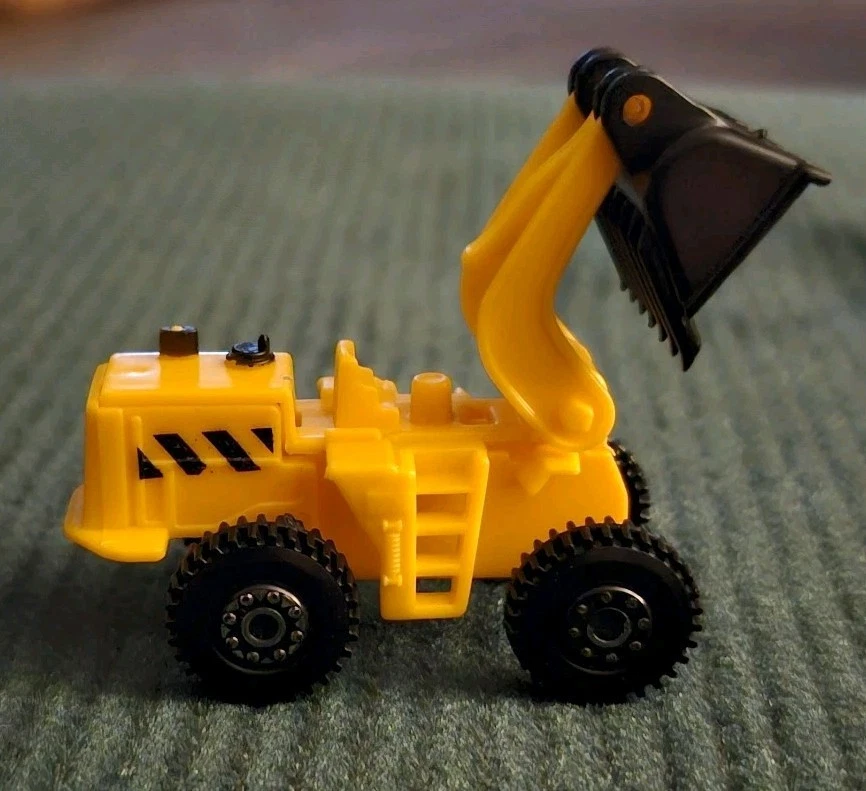 Excavadora de plástico vehículo cargador frontal amarillo 1:64 Foto 1 de 4