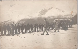 WW1 ERA RPPC POSTCARD - AUS-HUNGARIAN SOLDIERS SKI TRAINING-MOUNTINS BACKGROUD - Picture 1 of 2