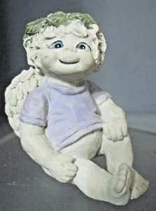IMPISH DREAMSICLE FIGURE SITTING WITH GREEN LAUREL WITH PURPLE SHIRT - Picture 1 of 4