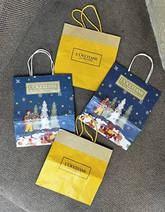 2 L’Occitane gelbe Papiereinkaufstaschen & 2 L’Occitane Weihnachtseinkaufstaschen - Bild 1 von 8