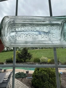 BOTELLA MEDICINAL VINTAGE ESCASA DE CURA DE CATARRO AFRICANO METZGER’S - Imagen 1 de 6