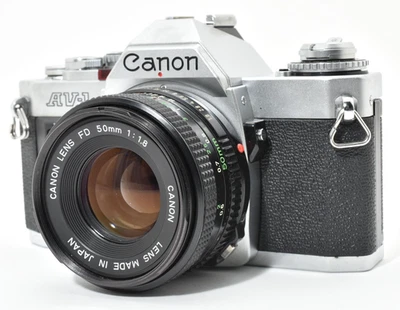 ▶️ Lente excelente Canon AV-1 negra SLR 35 mm cámara fotográfica FD 50 mm f/1,8 JAPÓN 2646659 Foto 1 de 4