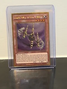 Yugioh - Buster Gundil The Cubic Behemoth (Gold Rare) (1st Edition) - MVP1-ENG35 - Picture 1 of 2