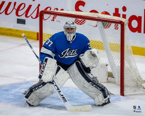 Connor Hellebuyck Winnipeg Jets Unsigned Alternate Jersey in Net Photograph Cover