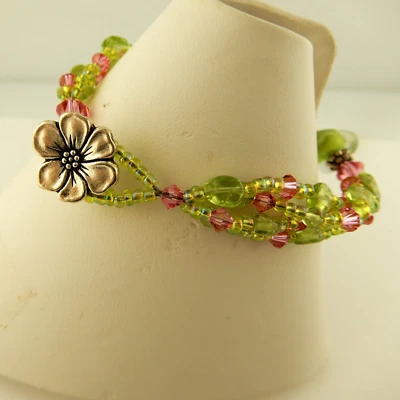 3 strand bracelet made w/ Swarovski, Peridot pink & green beads & flower clasp - Image 1 of 4