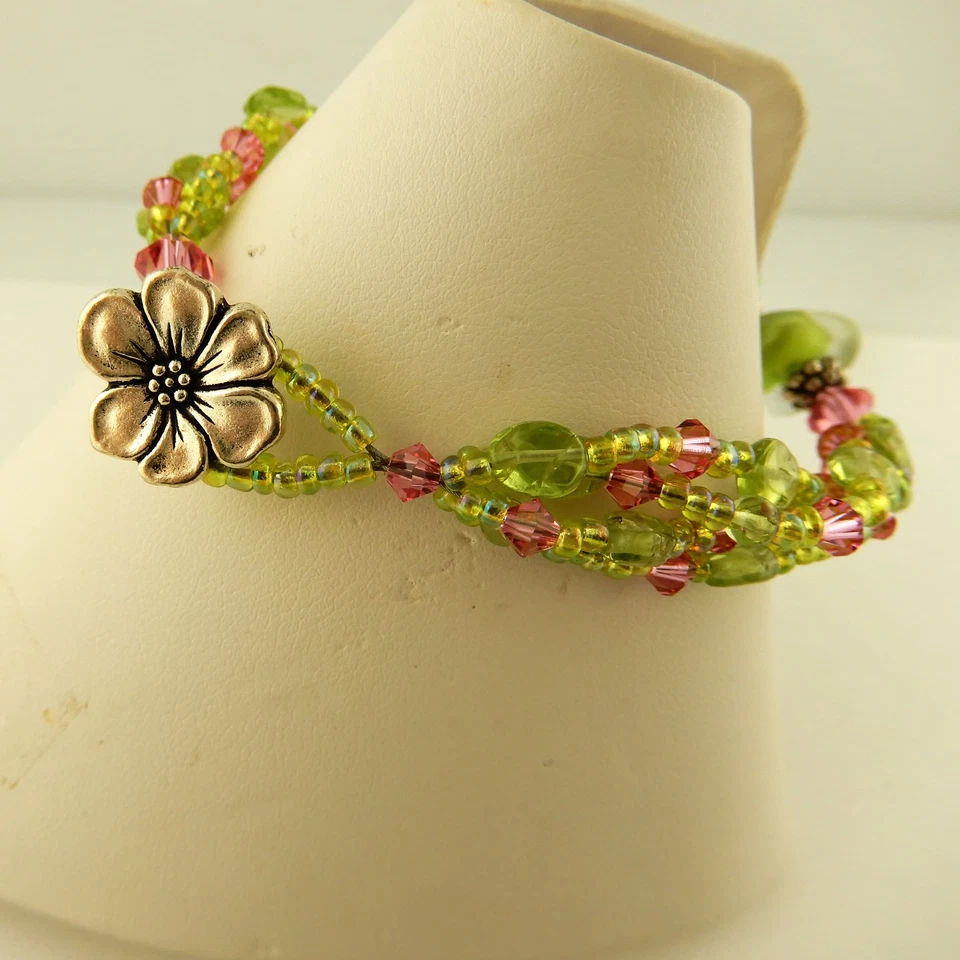 3 strand bracelet made w/ Swarovski, Peridot pink & green beads & flower clasp - Image 1 of 4