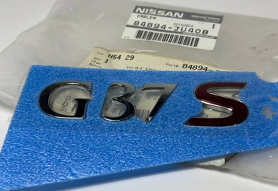 INFINITI G37 2009-2013 EMBLEMA MALETERO TAPA PLACA DE IDENTIFICACIÓN 84894JU40B OEM Foto 1 de 4
