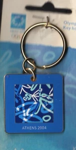 ATHENS 2004. OLYMPIC GAMES KEYCHAIN. SQUARE. BLUE MOTIFS OF THE GAMES - Picture 1 of 2