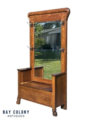 VICTORIAN TIGER OAK HALL TREE WITH BEVELED MIRROR & LIFT TOP SEAT ON CARVED LEGS - Image 1 of 4