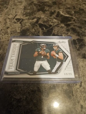 2022 Panini Absolute Carson Strong Jalen Hurts #TT-JC Team Tandem Dual Patch - Image 1 of 2