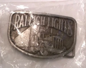 RALEIGH LIGHTS BELT BUCKLE TRACTOR TRAILER TRUCKS NEW IN SEALED PACKAGE - Picture 1 of 2