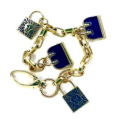 Pulsera Anne Klein Charm negra esmaltada bolso de mano y logotipo de león medallón barra eslabón de colección Foto 1 de 4