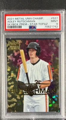 2021 Metal Univ. Champ #S27 Adley Rutschman Skybox Prem STAR TOPAZ PSA 9 POP 2 - Image 1 of 2