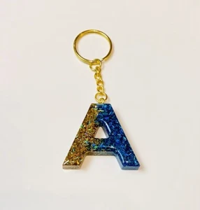 Llavero con letras doradas/azules brillantes - Imagen 1 de 1