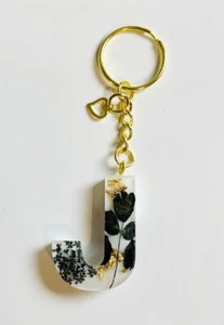 Schlüsselanhänger Buchstabe schwarz Blumen/weiß Harz - Bild 1 von 1