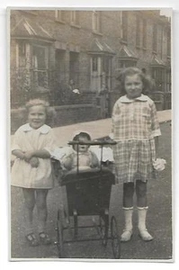 #114  RPPC Vintage Two young girls with Baby Doll in Carriage in neighborhood - Picture 1 of 2