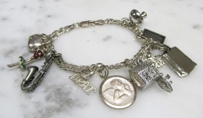 Sterling Silver Charm Bracelet with 10 Charms ~ 7-1/2" ~ 34.7grams ~ 2-A146 - Image 1 of 4
