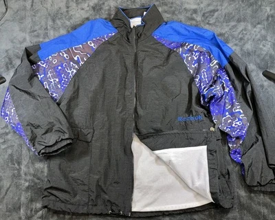 Chaqueta cortavientos vintage Reebok para hombre grande negra azul púrpura forrada de malla años 90... Foto 1 de 4