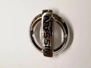 Genuine Nissan Grille Emblem 62889-1JA0A - Picture 1 of 3