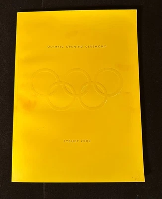 Libro programa ceremonia de apertura olímpica Sydney 2000 anillos amarillos en relieve ANZ Foto 1 de 4