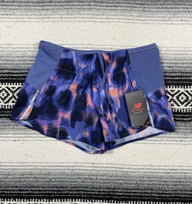 Shorts de corrida New Balance Impact 3" feminino XS roxo laranja bolso com zíper WS21276 - Imagem 1 de 4