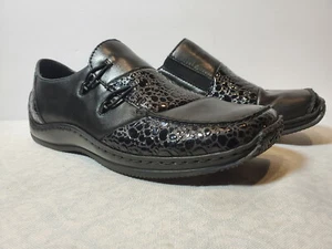 Planos para mujer RIEKER de cuero negro antiestrés sin cordones confort talla 37 EE. UU. 6 - Imagen 1 de 5