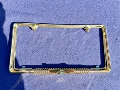 1958 Chevrolet Bel Air Biscayne NORS Accessory GOLD Bowtie License Plate Frame - Image 1 of 4