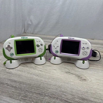 2 LeapFrog Leapster Explorer Handhelds With Docking Stations And 2 Games Tested - Image 1 of 4