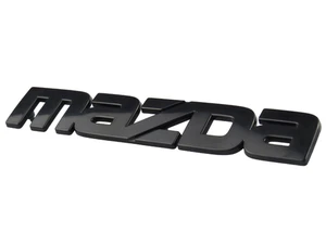 MAZDA Genuine F023-51-770A 84-85 RX-7 "Black Front Bumper Emblem Ornament Plate - Picture 1 of 1