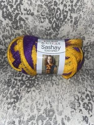Red Heart Boutique Sashay Team Spirt Ribbon Yarn 1933 Purple/Gold 3.5oz LSU - Image 1 of 3