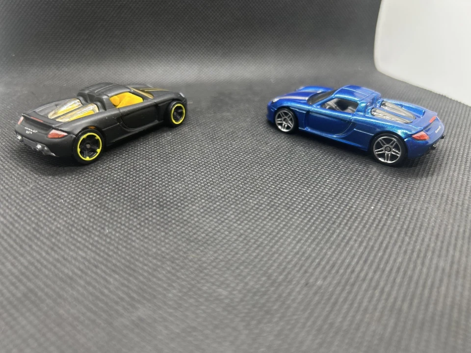 Hot Wheels HW Exotics 4/10 черный Porsche Carrera GT синий Carrera GT 2 автомобиля отдельно - Изображение 1 из 4