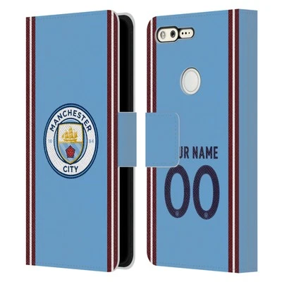 KIT DE INSIGNIA PERSONALIZADO MANCHESTER CITY FC 2022/23 FUNDA LIBRO DE CUERO PARA TELÉFONOS GOOGLE Foto 1 de 4