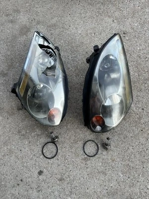 2003 2004 2005 2006 2007 Infiniti G35 Coupe Headlight Set Pair Used Eyelets OEM - Image 1 of 4