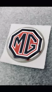 Mg SELF ADHESIVE STEERING WHEEL/GEARKNOB BADGE 27mm - Picture 1 of 1